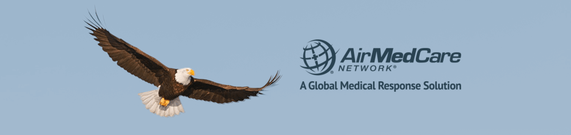 Bald eagle flying in the sky. AirMedCare Network logo. A Global Medical Response Solution